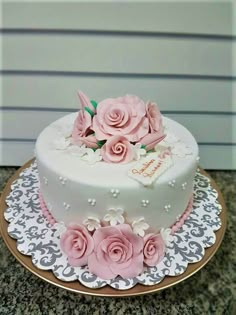 a white cake with pink flowers on top