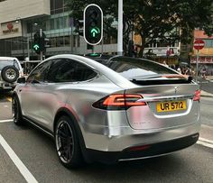 a silver car is stopped at an intersection