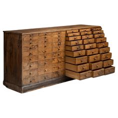 an old wooden dresser with many drawers on it's front and back sides, against a white background