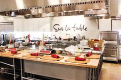 an industrial kitchen with stainless steel appliances and wooden cutting boards