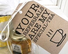 a bottle of honey sitting on top of a counter next to a bag with the label