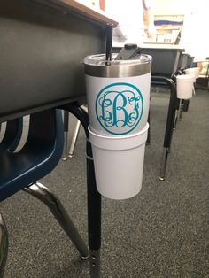 a coffee cup sitting on top of a metal table