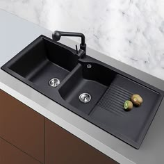 two black sinks sitting on top of a counter