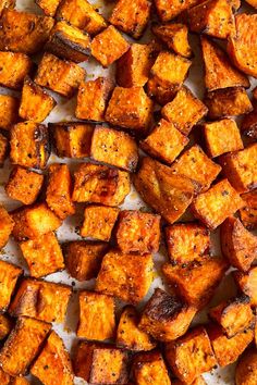 roasted sweet potatoes on a baking sheet ready to be cooked in the oven for dinner