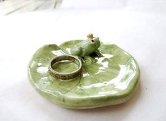 a ring dish with a frog on it