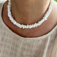 "This unique necklace is made with 10mm pure white artisan grade Queen scallop shells from the North Atlantic. The disc cut of the shell is organic, wavy and asymmetrical. The beads are tumbled to smooth the edges and give the beads a fine satin finish. The appearance of the finished piece is carefree, light and airy. Great necklace to wear on a beautiful summer day. - Not dyed, treated or color enhanced. 100% natural. - Photos taken outside in natural lighting and in a light box.  - No filters Handmade White Shell Jewelry, White Shell Necklace With Natural Stones, Handmade White Shell Necklaces, Elegant White Shell Necklace With Natural Stones, Adjustable White Single Strand Jewelry, White Mother Of Pearl Necklace For Beach, White Round Beads Shell Necklace As Gift, White Gemstone Beads Necklace, White Bohemian Jewelry In Mother Of Pearl