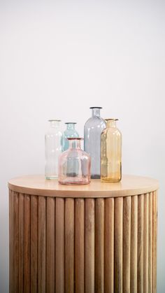 three vases sitting on top of a wooden table