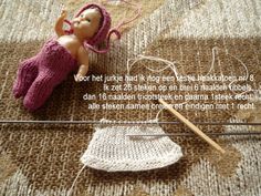 a doll is laying on the floor next to some knitting needles and an object that has been knitted