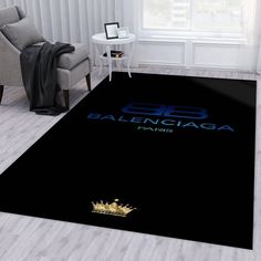 a black area rug with the word balengaga printed on it in gold lettering