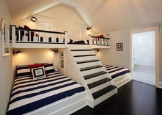 there is a bunk bed with stairs in the room that has two beds on it