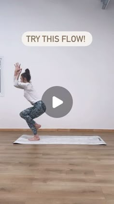 a woman is doing yoga in front of a wall with the words try this flow