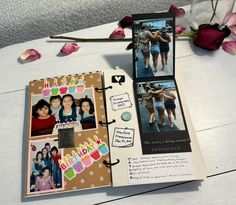 an open scrapbook with pictures and flowers