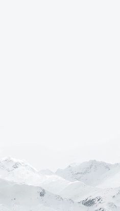 two people on skis in the snow with mountains in the background