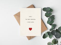 a card with the words, i love you written on it next to some leaves