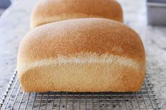 two loaves of bread cooling on a rack