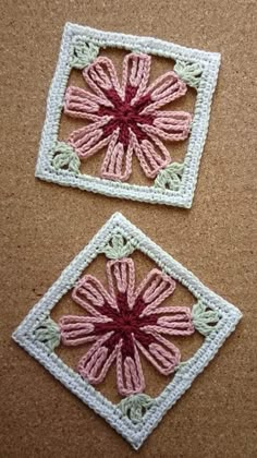 two crocheted squares with pink and green designs on them, one has a flower in the center