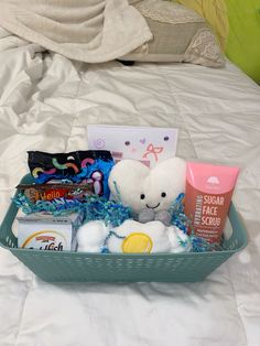 a basket filled with lots of items on top of a bed