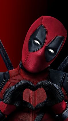 the deadpool character is holding two knives in his hands and wearing a red mask