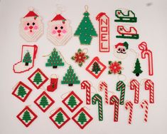 christmas ornaments are arranged on a white surface, including santa's and other holiday decorations