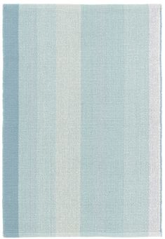 a blue and white rug with vertical stripes