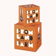 two orange boxes with the words from land to farm printed on them, sitting side by side