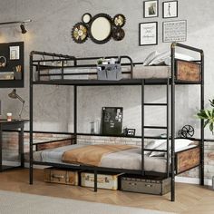 a metal bunk bed with two drawers and a desk in front of it, next to a brick wall