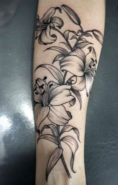 a black and white flower tattoo on the leg