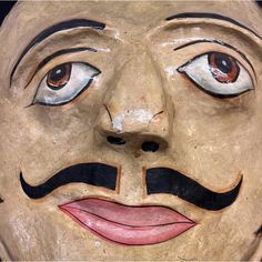 a close up of a face with a moustache on it