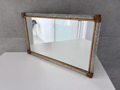 a mirror sitting on top of a white table