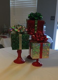 three wrapped presents sitting on top of a table