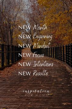 a wooden path with the words new month and beginning in white on it, surrounded by fall leaves