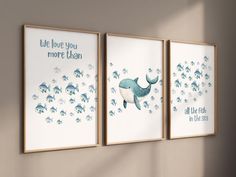 three framed posters on the wall in a child's room, one with a whale and another with fish