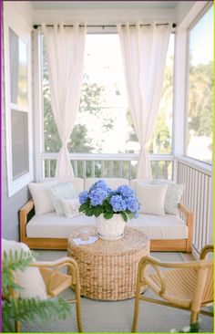 a living room filled with furniture and blue flowers