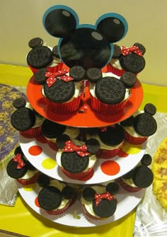 cupcakes are stacked on top of each other with mickey mouse heads in the middle