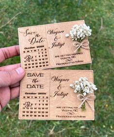 two wooden save the dates magnets with baby's breath flowers tied to them