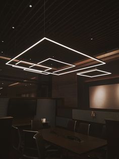 an empty conference room with wooden tables and chairs