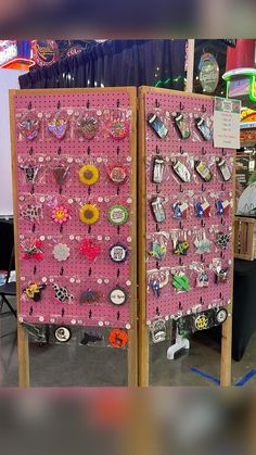 two pink pegboard displays with lots of pins and earrings