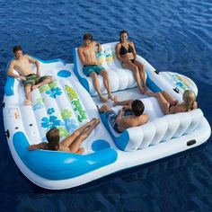 several people are sitting on an inflatable raft floating on the water