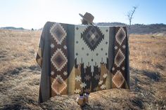 a person standing in a field with a blanket