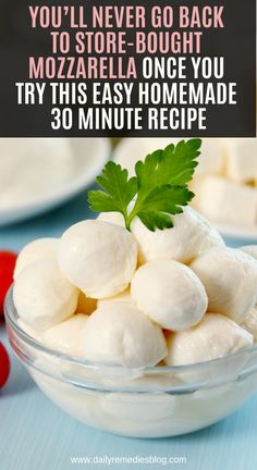 a glass bowl filled with mozzarella cheese on top of a blue table