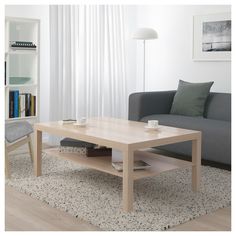 a living room with a couch, coffee table and bookshelf