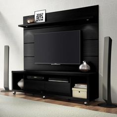 a black entertainment center with speakers and a flat screen tv