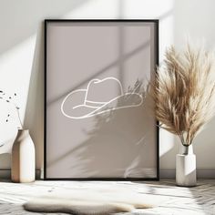 an image of a hat on the wall next to some vases and dried grass