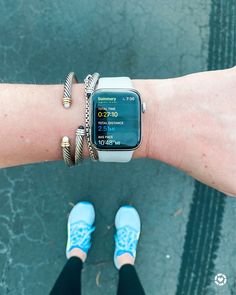 an apple watch on someone's arm with two bracelets around it and the time displayed