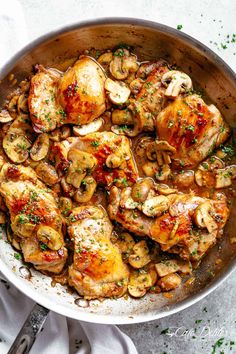 a pan filled with chicken thighs and mushrooms