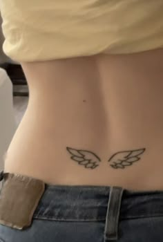 a woman's stomach with two wings on it