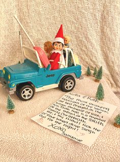 an elf is in the back of a toy truck with a dog inside and a note to santa