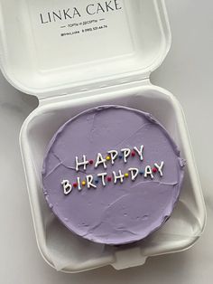 a birthday cake in a white container with the words happy birthday written on it