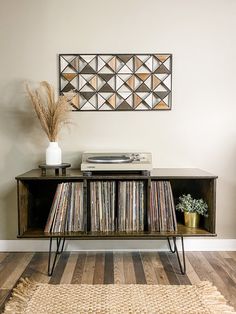 a record player on top of a wooden shelf with vinyl records in front of it