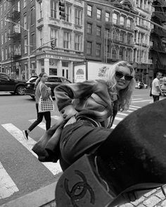 a black and white photo of a woman on the street